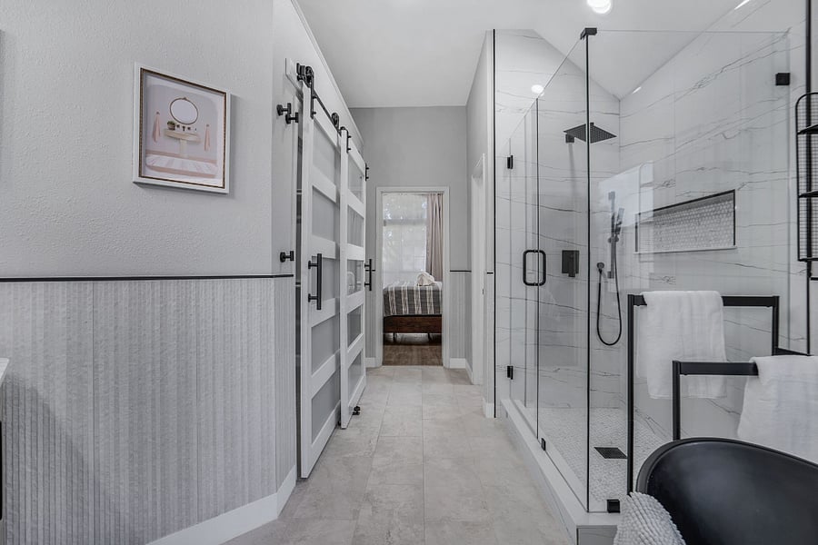 View of primary bedroom from primary bathroom