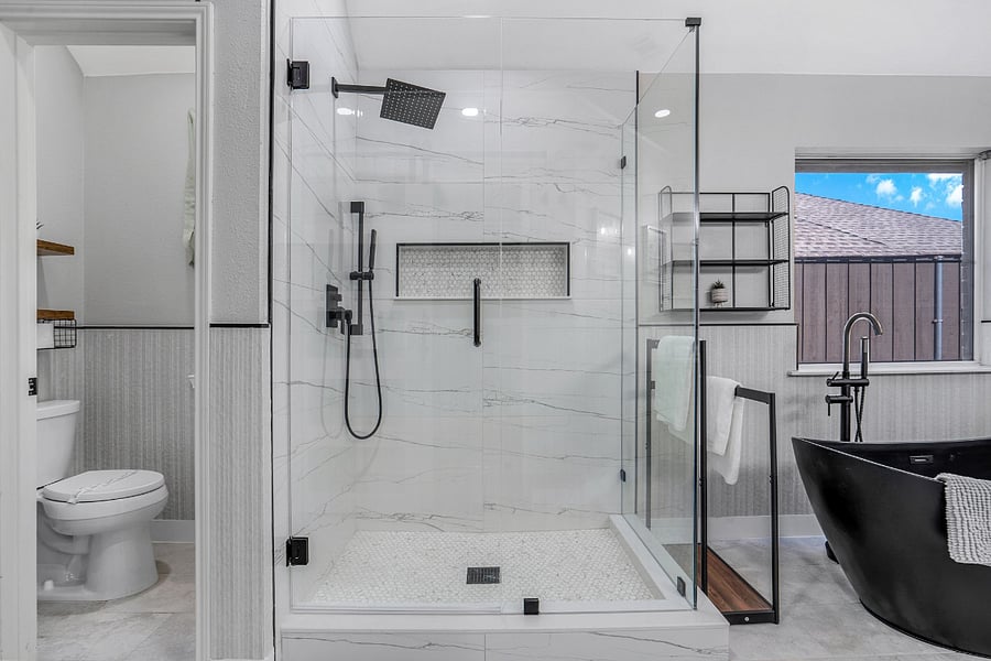 Primary bathroom with large tiled walk-in shower, rain shower head, handheld, soaking tub, and dual vanity