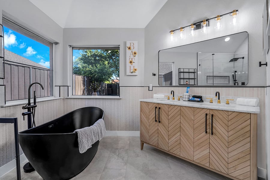View of vanities, hollywood tub and primary bathroom. Windows are now opaque glass for privacy