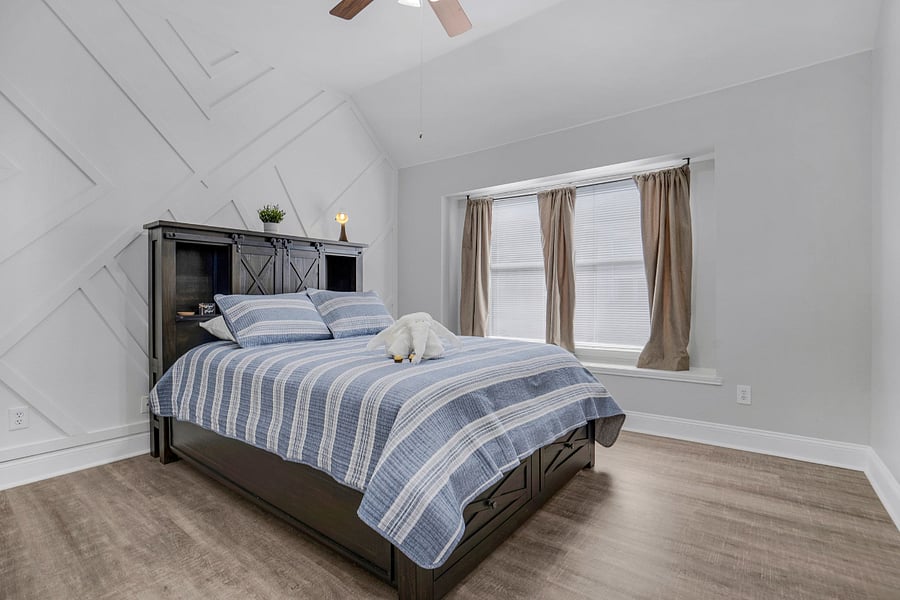 Queen bed with window and block out curtains and blinds