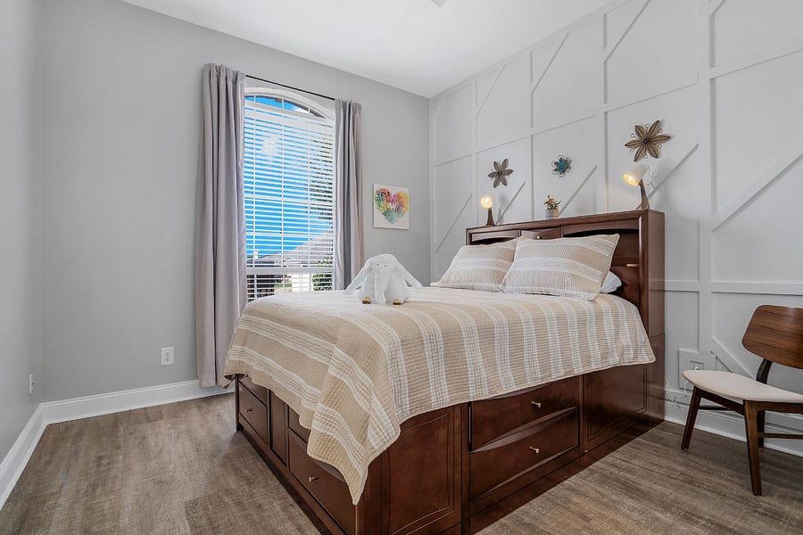 Queen bed with built in storage in base with closet and ceiling fan