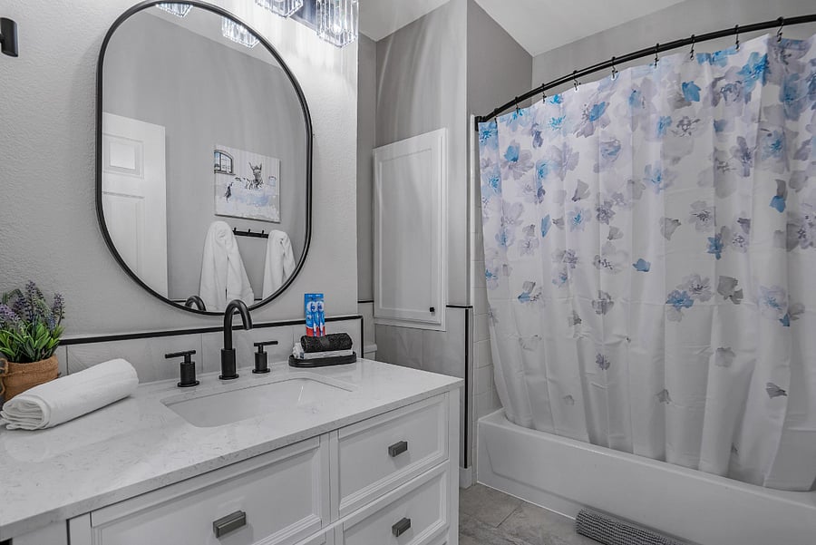 Secondary bathroom with shower/tub combo, centrally located between guest bedrooms