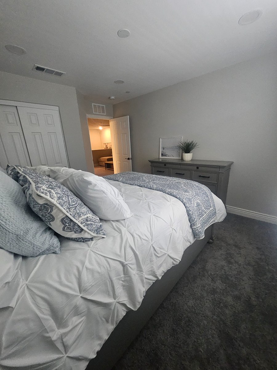 Upstairs, right-side bedroom, Queen size bed with one side table, dresser and extra linen