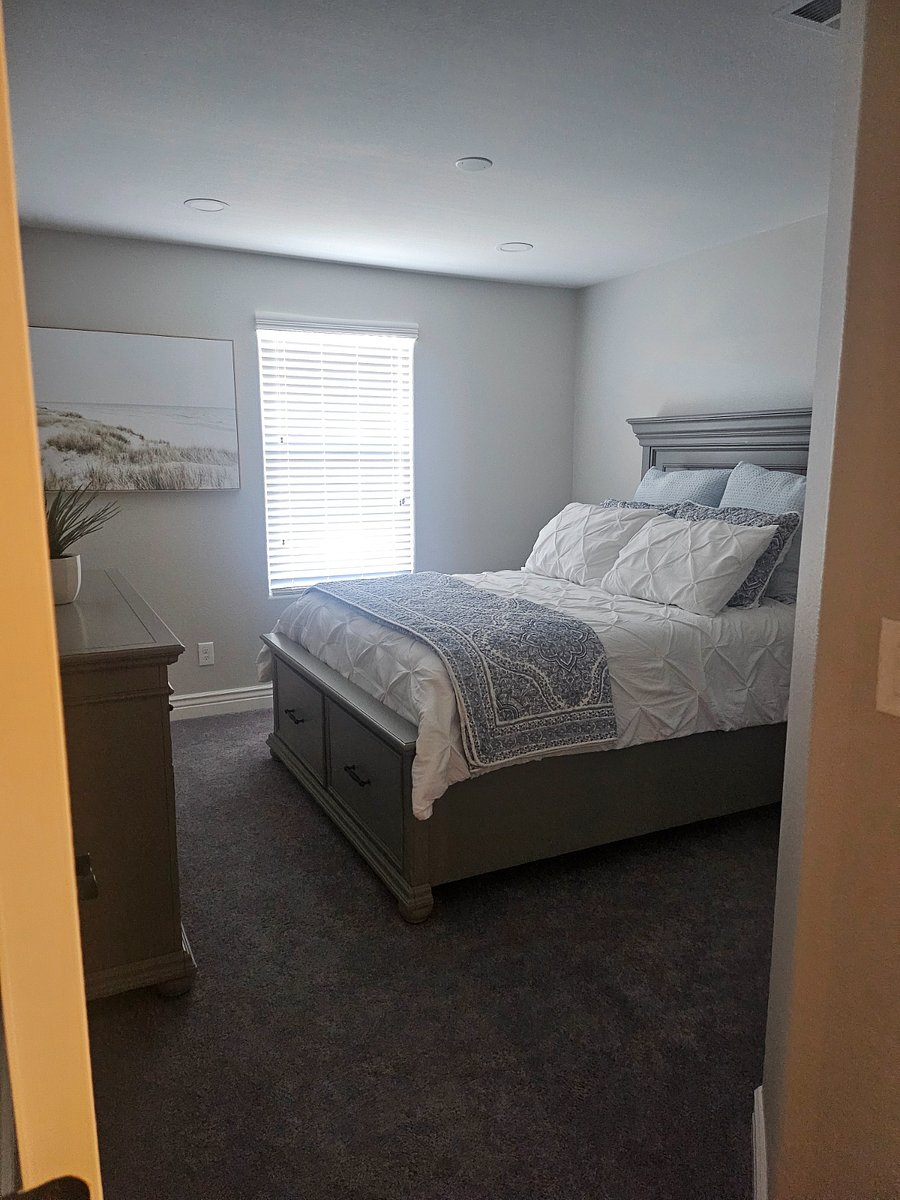 Upstairs, right-side bedroom, Queen size bed with one side table, dresser and extra linen