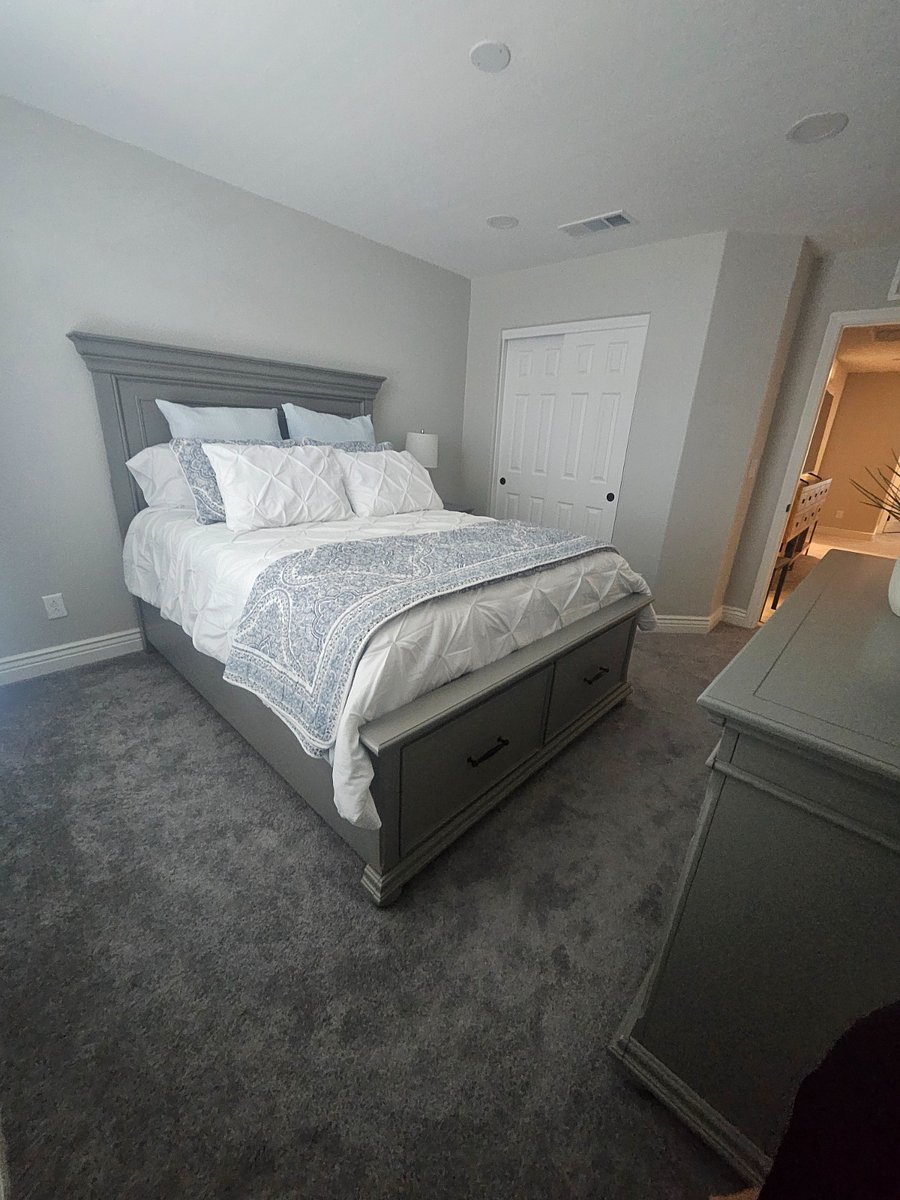 Upstairs, right-side bedroom, Queen size bed with one side table, dresser and extra linen