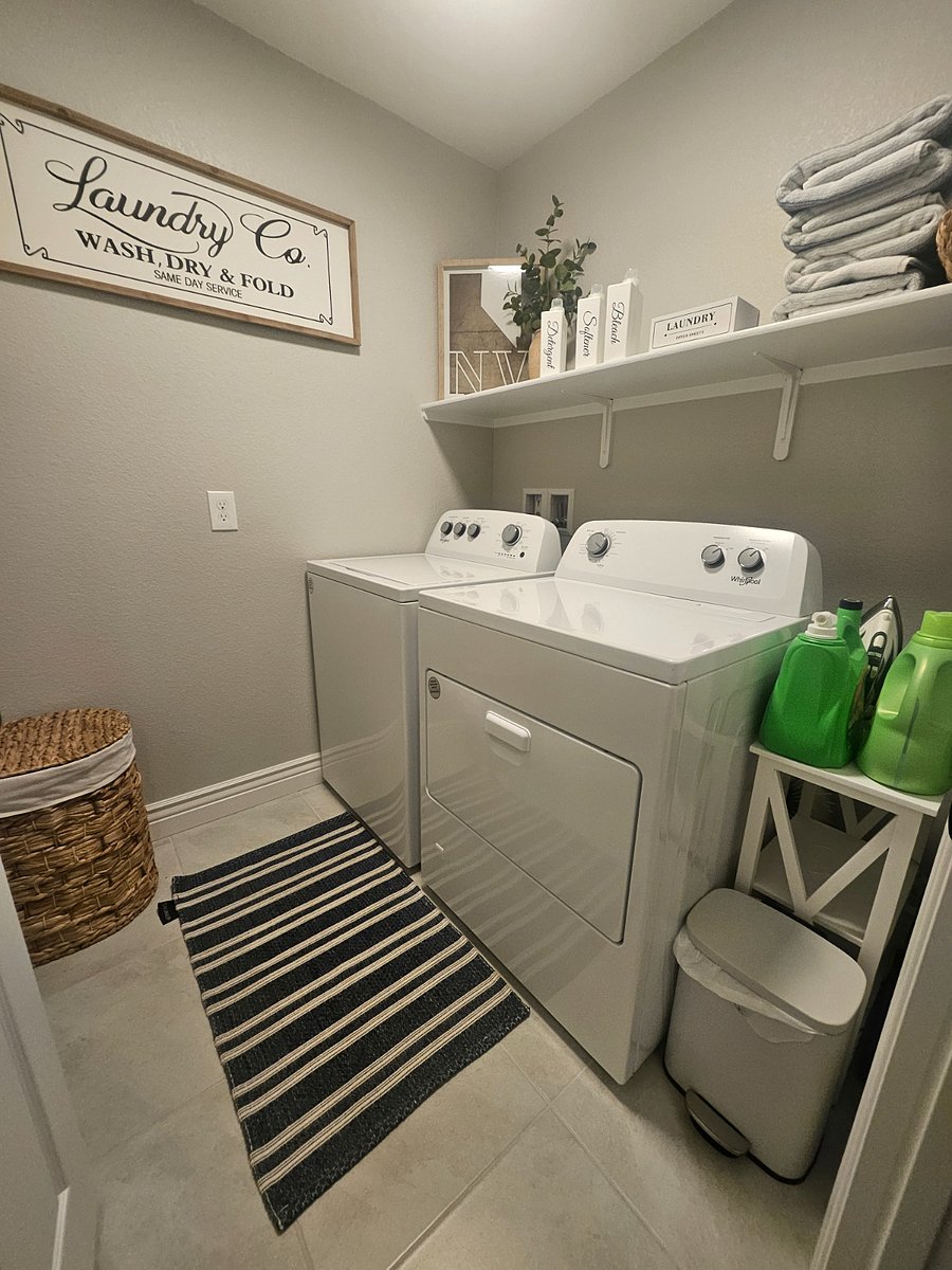 Upstairs laundry room with ironing board and iron
