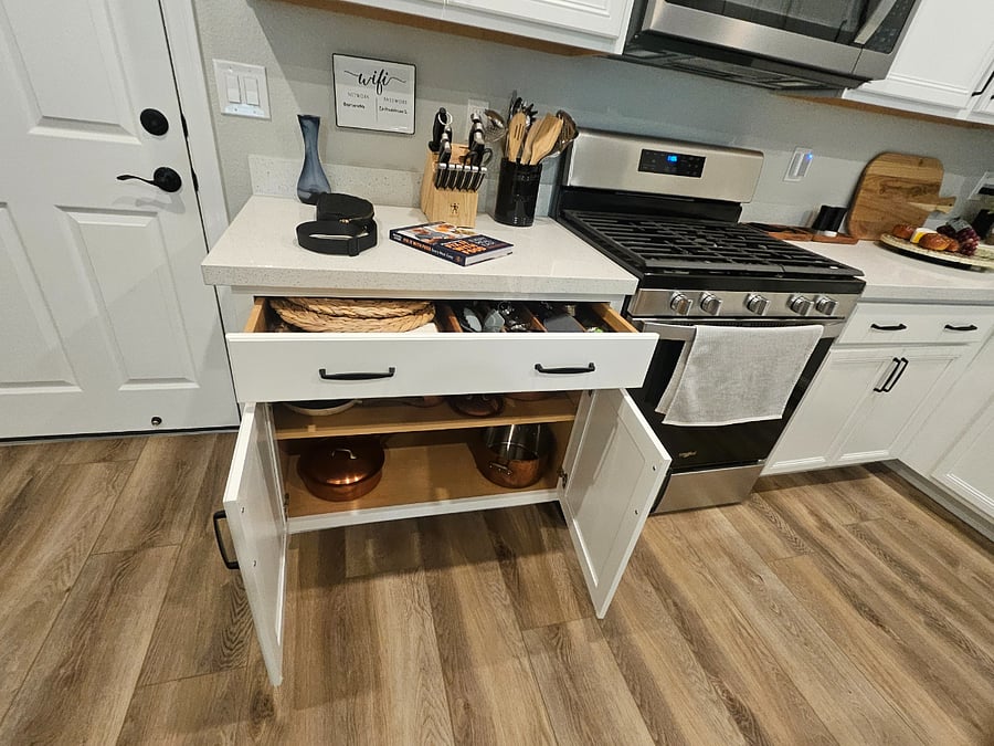 Kitchen has cooking utilities and pots and pans