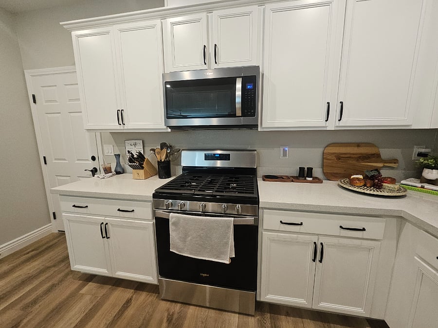 Kitchen has microwave and stovetop with oven