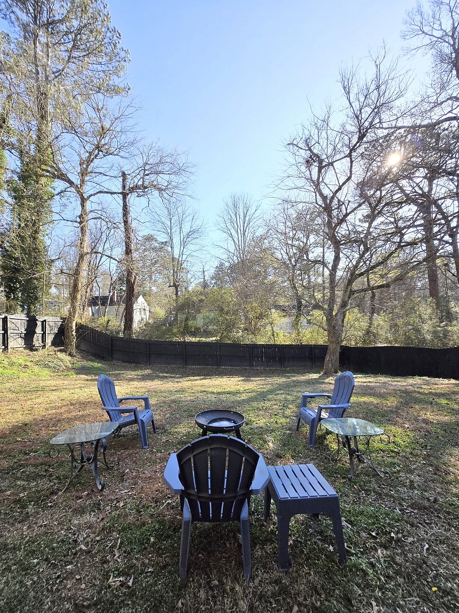 Fenced in backyard with outdoor seating and fire pit. Firewood provided.