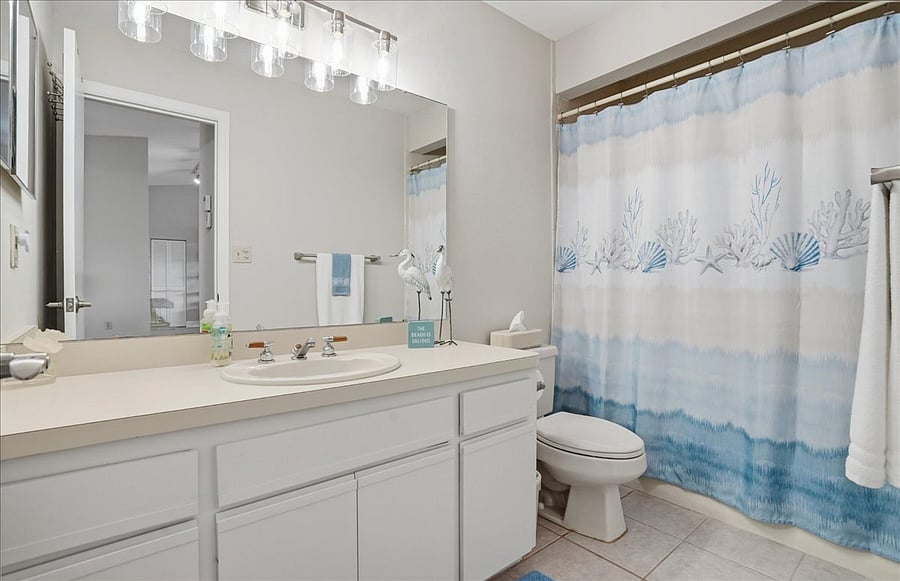 Full bathroom with entrance to living area close to 3rd bedroom