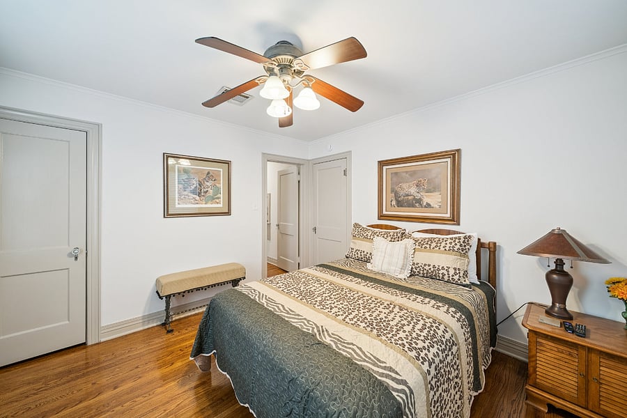 Bedroom #1 is located at the front of the home just off the living room. This comfortable room features a queen-size bed, ceiling fan, Smart TV, and closet, providing a relaxing and comfortable space to unwind after a day of work or exploring Tulsa.