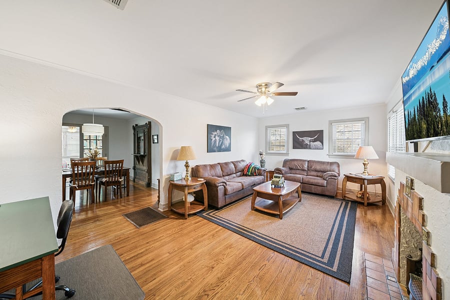 A fourth view of the living room showcases the home's beautiful original architecture, featuring the elegant arched doorway that reflects the timeless craftsmanship of this 1920s home. These preserved architectural details add warmth, charm, and character, blending historic appeal with modern comfort.