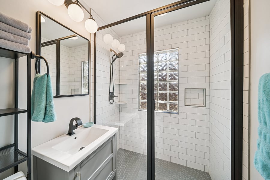 The main bathroom has been completely updated while maintaining the home's charm. It features a spacious walk-in tiled shower with a handheld shower head, providing both comfort and convenience. Bright, clean, and thoughtfully designed, this bathroom offers everything guests need for a relaxing and comfortable stay.