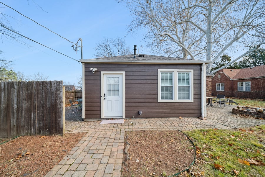 This view shows the guest entrance located at the rear of the home, just off the private driveway. Most guests use this entrance for its convenience, offering easy access to the home with nearby parking. The back entrance leads directly into the laundry room and kitchen, making unloading luggage and groceries quick and easy.