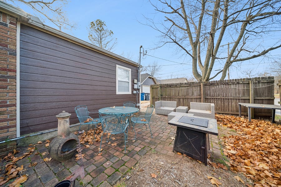The side patio offers a private, fenced outdoor space where guests can relax and enjoy the fresh air. Furnished with comfortable seating, it's the perfect place to enjoy your morning coffee, read a book, or unwind after a busy day. The fenced patio provides added privacy, creating a peaceful outdoor retreat during your stay.