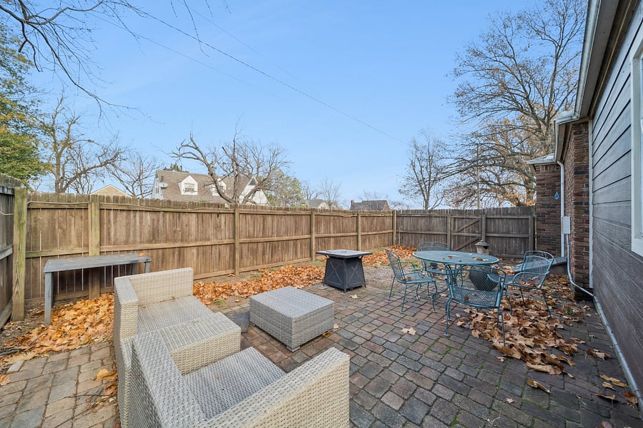 The side patio offers a private, fenced outdoor space where guests can relax and enjoy the fresh air. Furnished with comfortable seating, it's the perfect place to enjoy your morning coffee, read a book, or unwind after a busy day. The fenced patio provides added privacy, creating a peaceful outdoor retreat during your stay.