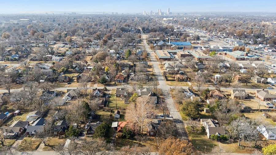This aerial view showcases the home's excellent location on a corner lot. Looking to the right, you can see Historic Route 66, located just a couple of blocks away. This prime location places guests within easy walking or driving distance of one of America's most famous highways, known for its unique restaurants, local shops, historic landmarks, and rich Oklahoma history. It's the perfect home base for exploring Tulsa while enjoying the charm of a historic neighborhood.