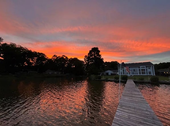 Peaceful lakeside sunset with a private dock, calm waters, and stunning evening skies.