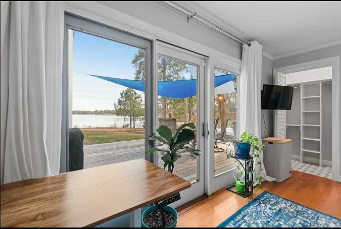 Bright living space with large sliding glass doors and beautiful lake views.