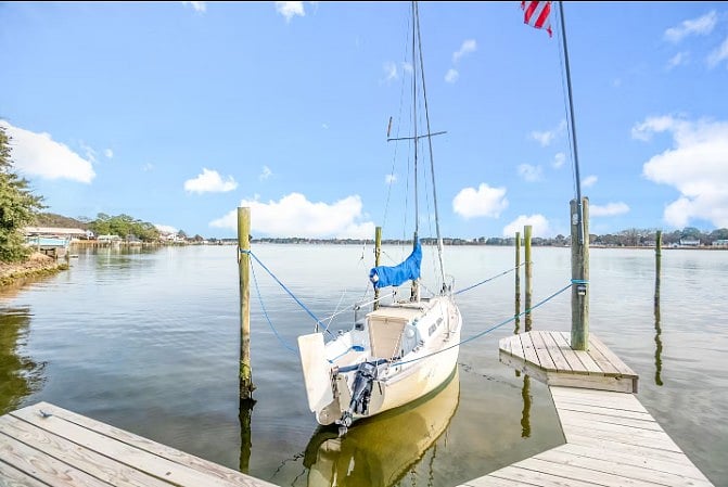 Private dock with a sailboat, offering direct lake access and peaceful waterfront views.