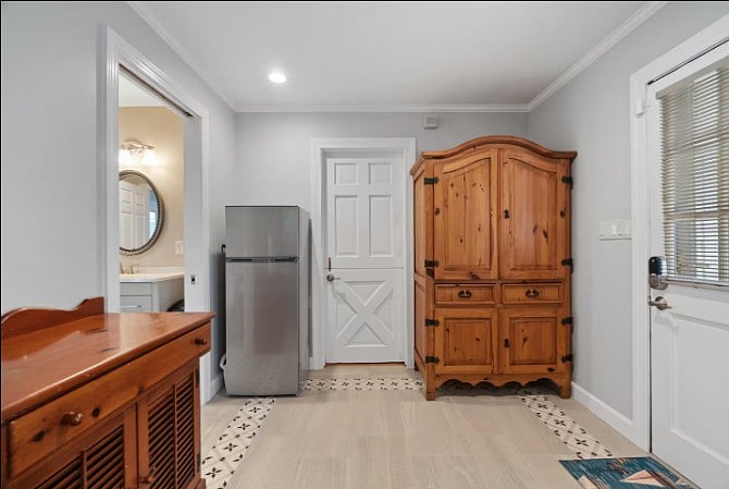 Clean, well-organized space featuring a mini refrigerator and ample storage cabinets.
