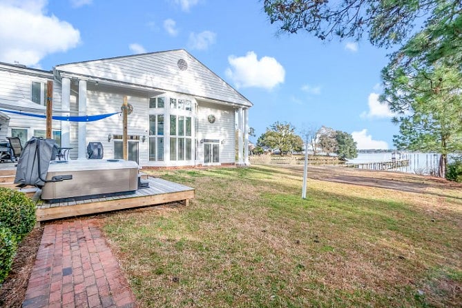 Spacious backyard with private hot tub and direct lake access.