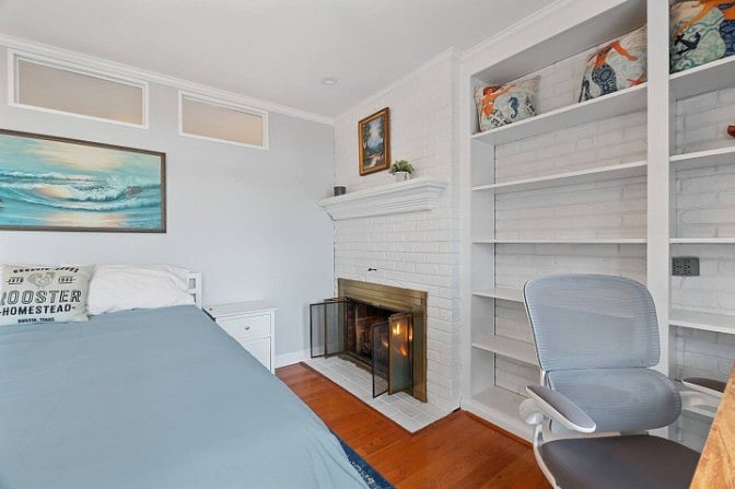 Modern queen bedroom featuring stylish furnishings, soft textures, and a warm, inviting feel.