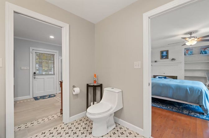 Spacious bathroom layout with easy access to the bedroom and entry area.
