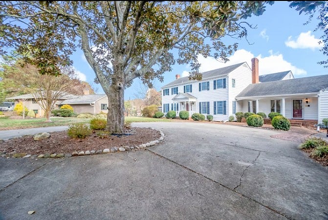 Beautifully maintained exterior with brick walkway and covered entry.