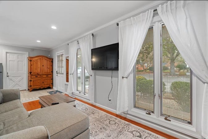 Comfortable seating area with a smart TV and peaceful outdoor views.