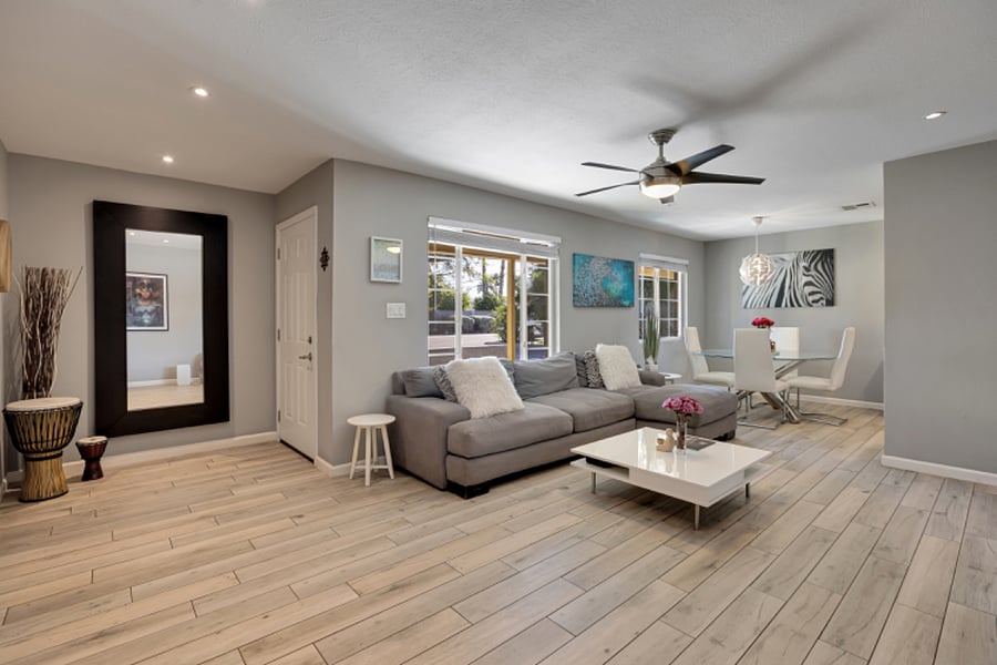 Bright, spacious living room featuring contemporary finishes and porcelain tile flooring