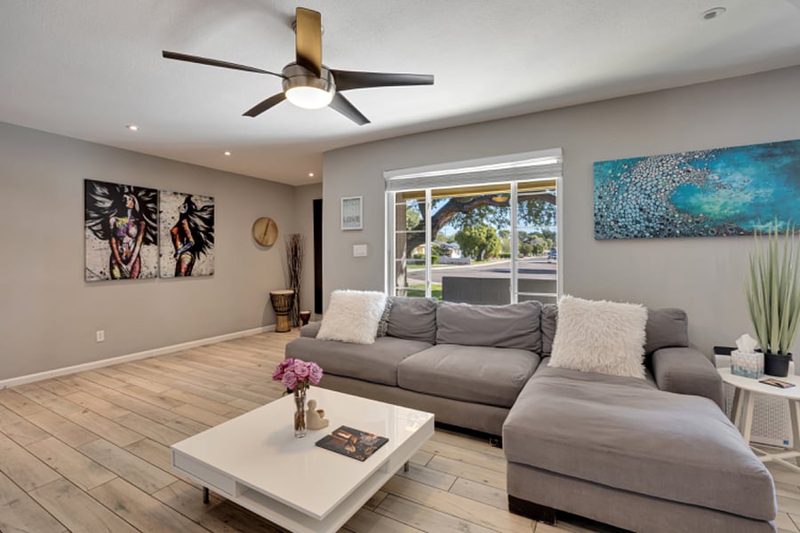 Spacious living room with large picture window, abundant natural light, and contemporary modern decor