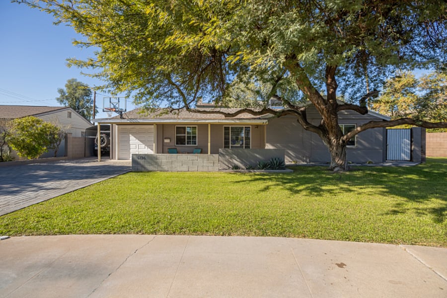 Front of home featuring mature mesquite tree w/lots of natural shade and charming curb appeal
