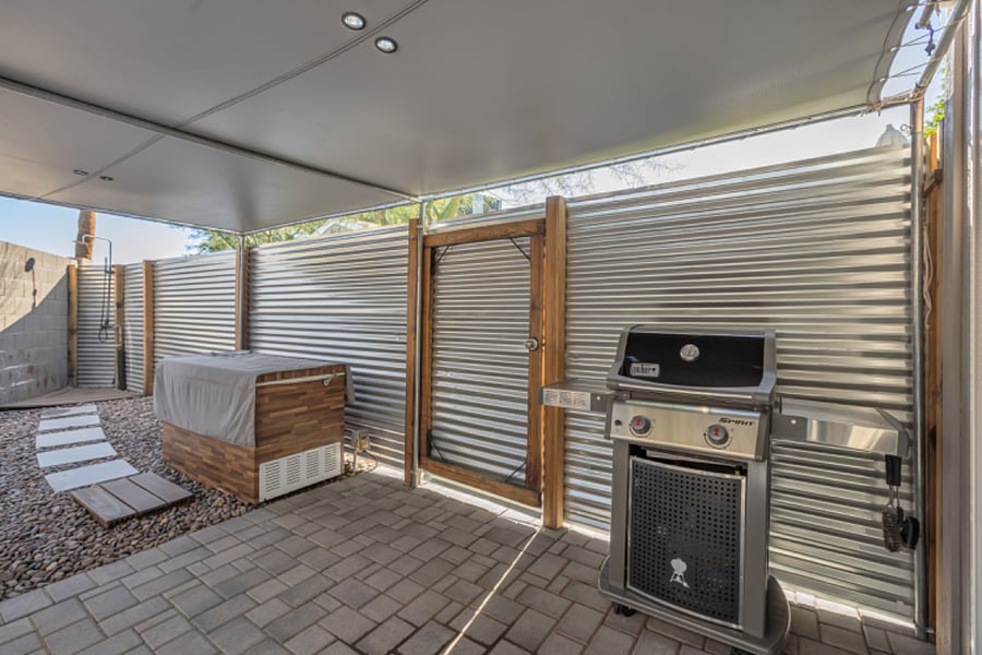 Ice bath area with nearby gas barbecue and outdoor utility space