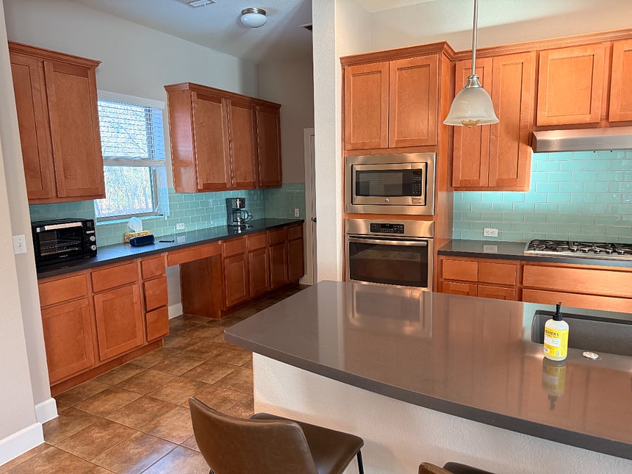 more cabinets and countertop space around the corner into the pantry in the kitchen