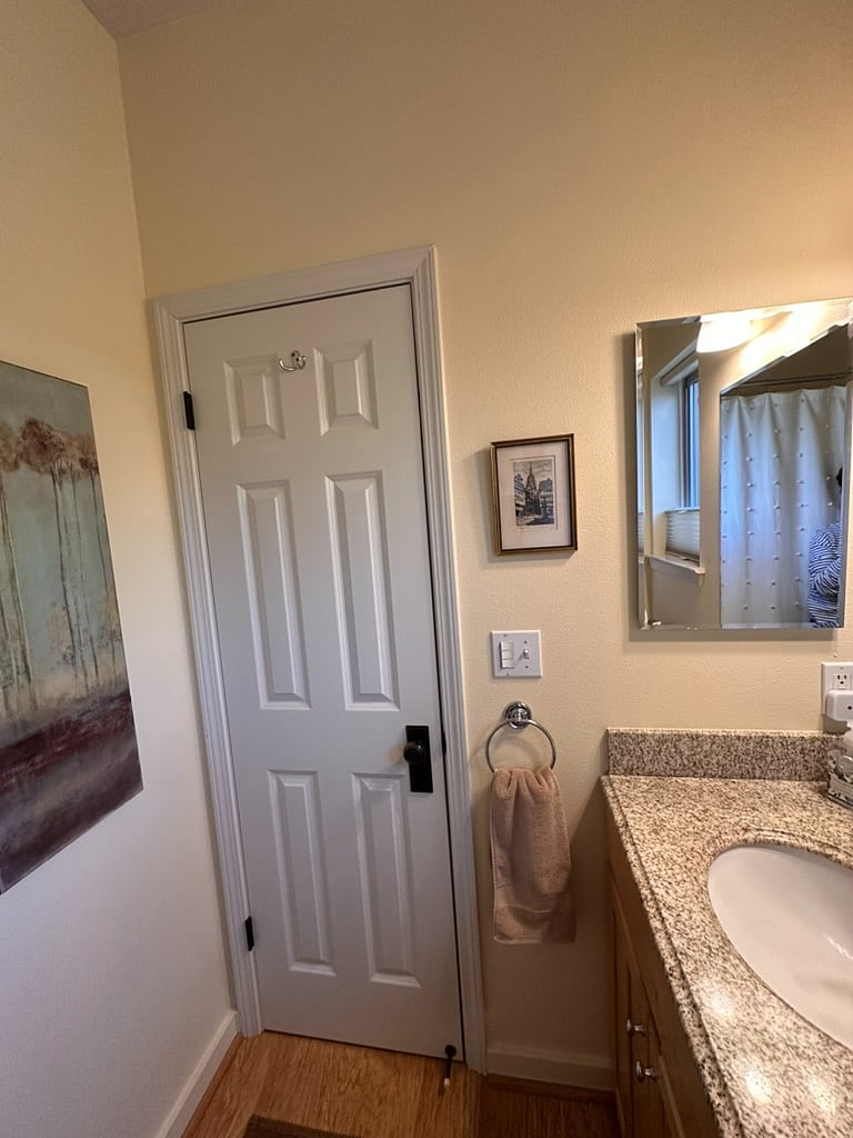 Medicine cabinet for toiletries with a pullout bin under the vanity sink for additional storage.