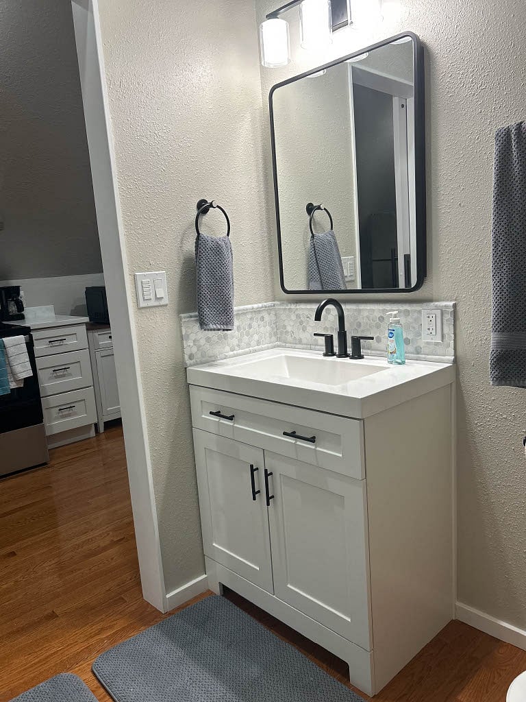 Bathroom: Vanity mirror opens for more storage