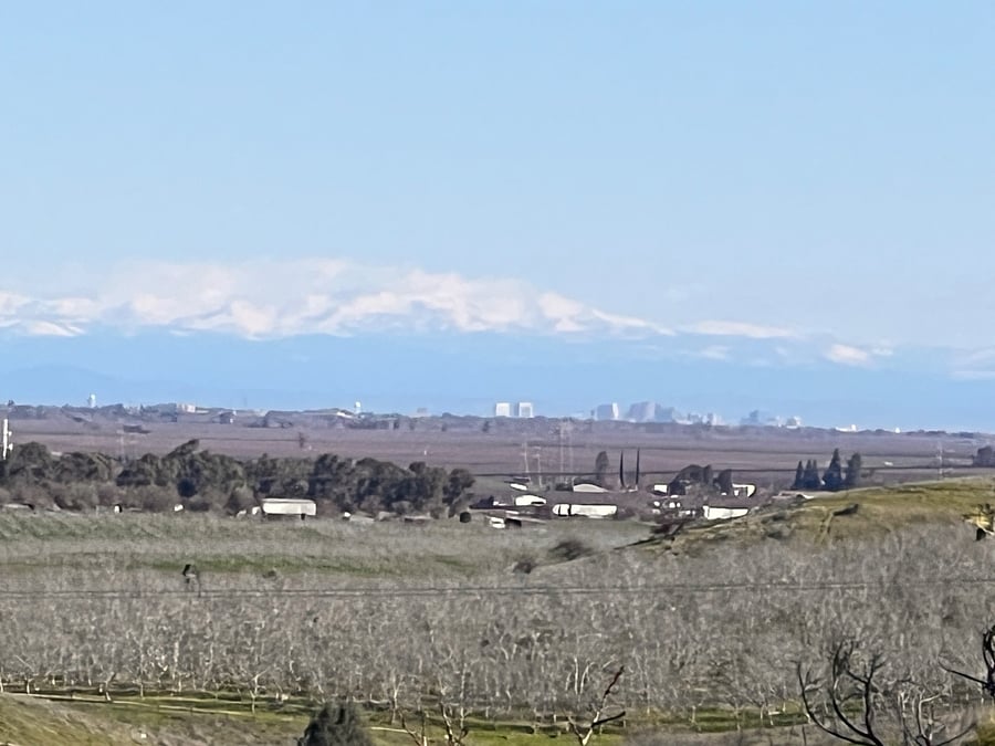 A view from the top of our hill of the snow-covered Sierra Nevada Mountains and Downtown Sacramento