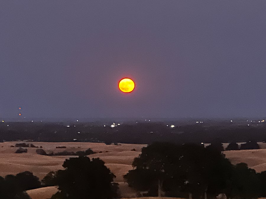 Amazing Full Moon rises from the hilltop