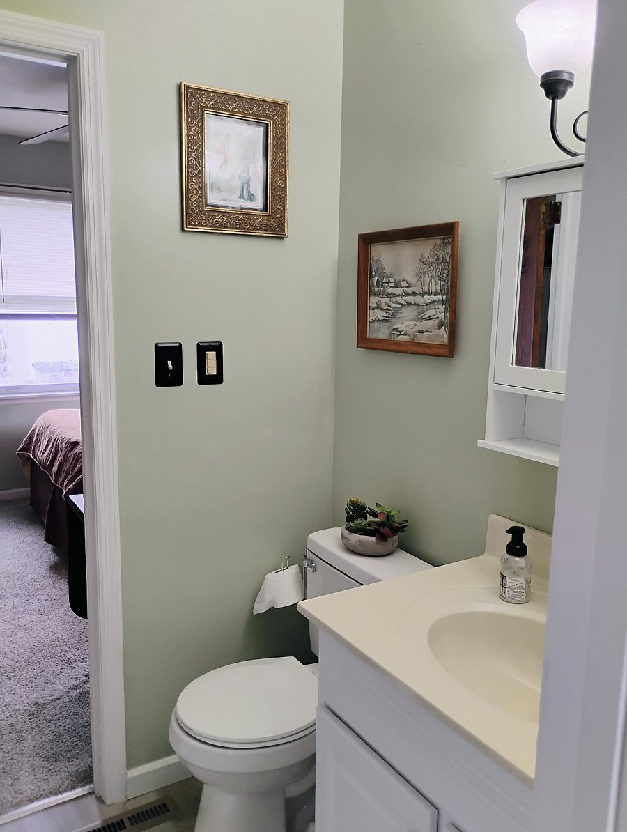 Bathroom looking to darker bedroom kitchen