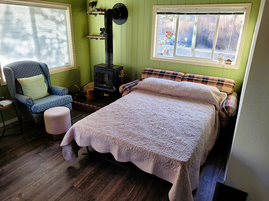 Living room pullout bed and wood stove