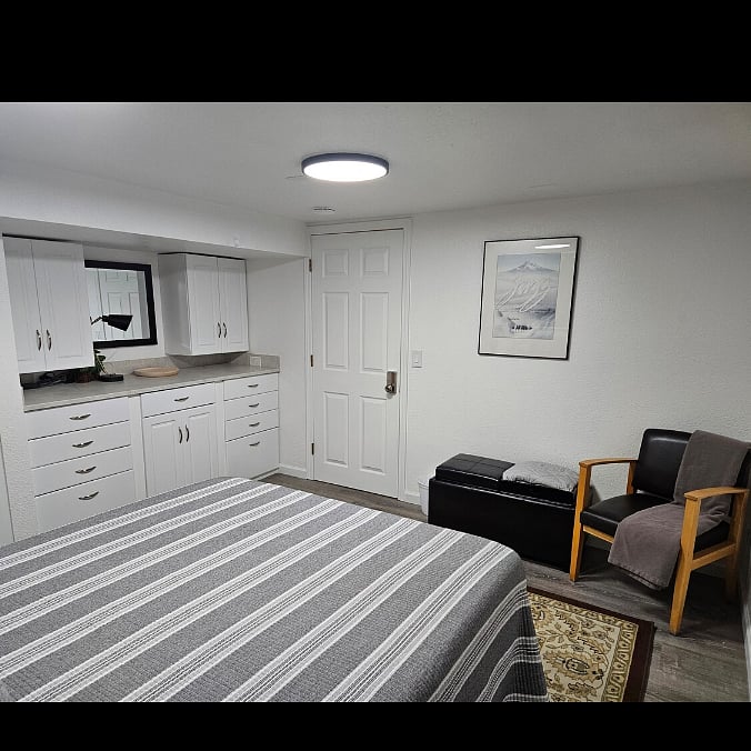 Bedroom 1. View of storage and table.