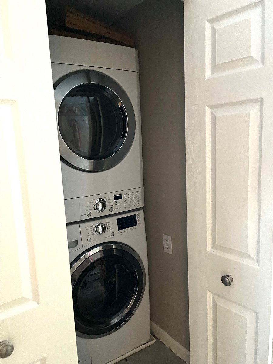 The washer and dryer are located on the first floor inside of a pantry.