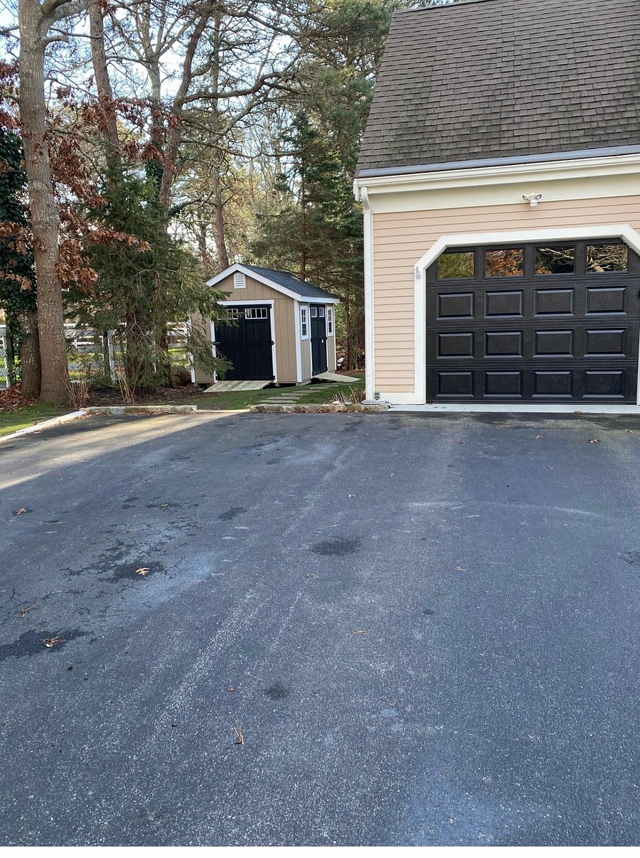 Uncovered parking space available to the left of the garage.