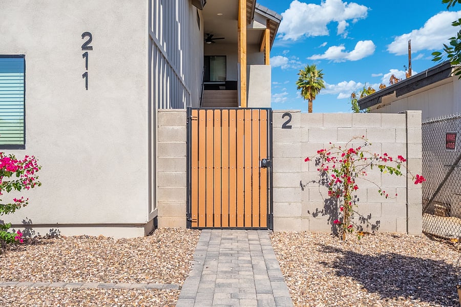 Welcome to your private desert oasis! A secure, electronic-lock gate opens up to your exclusive modern retreat.