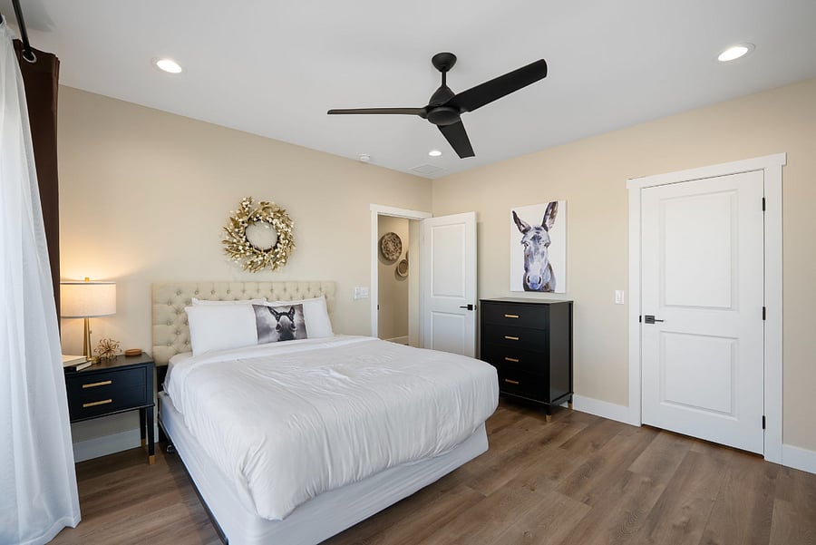 Welcome to a masterfully designed guest oasis that perfectly balances modern farmhouse charm with cozy, bohemian accents. This view showcases a spacious layout with multiple entry points, making it an incredibly functional and private retreat.