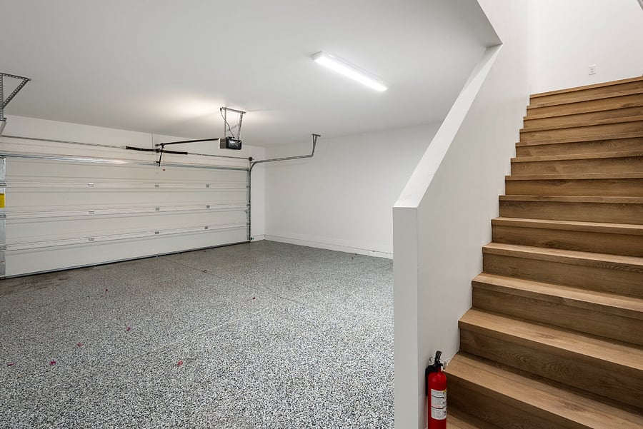 Park with ease and walk right up! Elegant wooden stairs lead you directly from the secure garage up into your private living space.