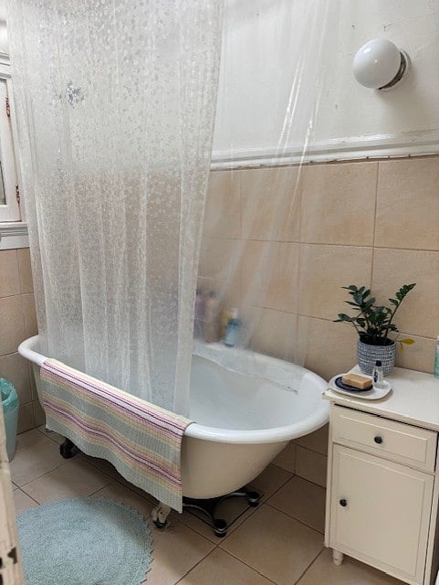 Light-filled, clean, shared bathroom with skylight and clawfoot tub and shower for old-school Victorian charm.