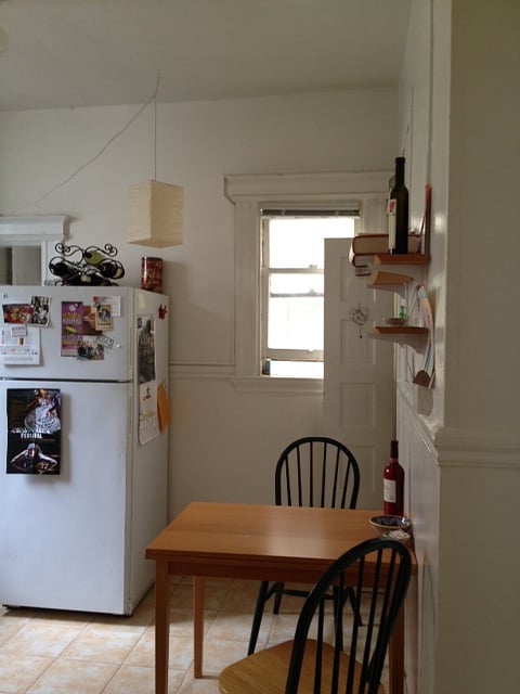 Fully equipped and organized shared kitchen with gas stove and full-sized refrigerator.