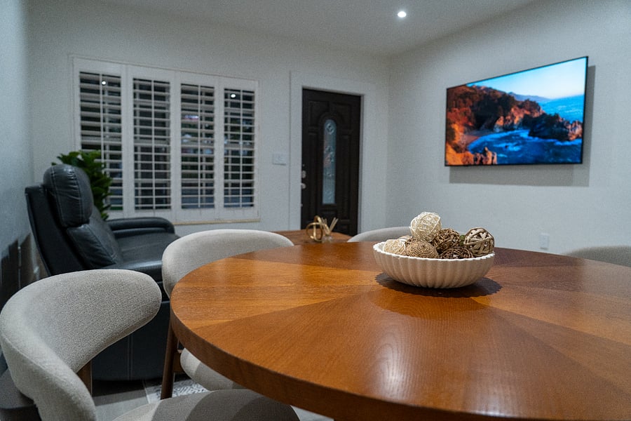 Living room and dining room with 65-inch TV.